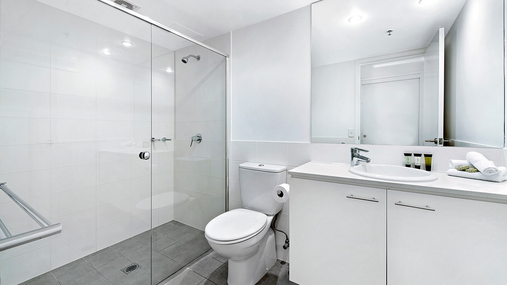 Bathroom with walk-in glass shower and modern vanity in the 3 Bedroom Apartment at ULTIQA Freshwater Point Resort.
