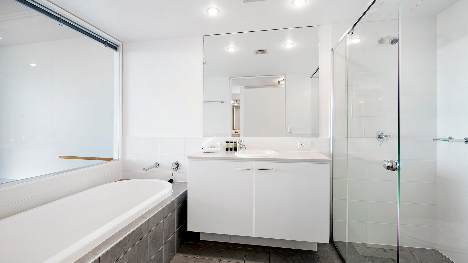 Modern bathroom with bathtub, walk-in shower, and large vanity in the 3 Bedroom Apartment at ULTIQA Freshwater Point Resort.