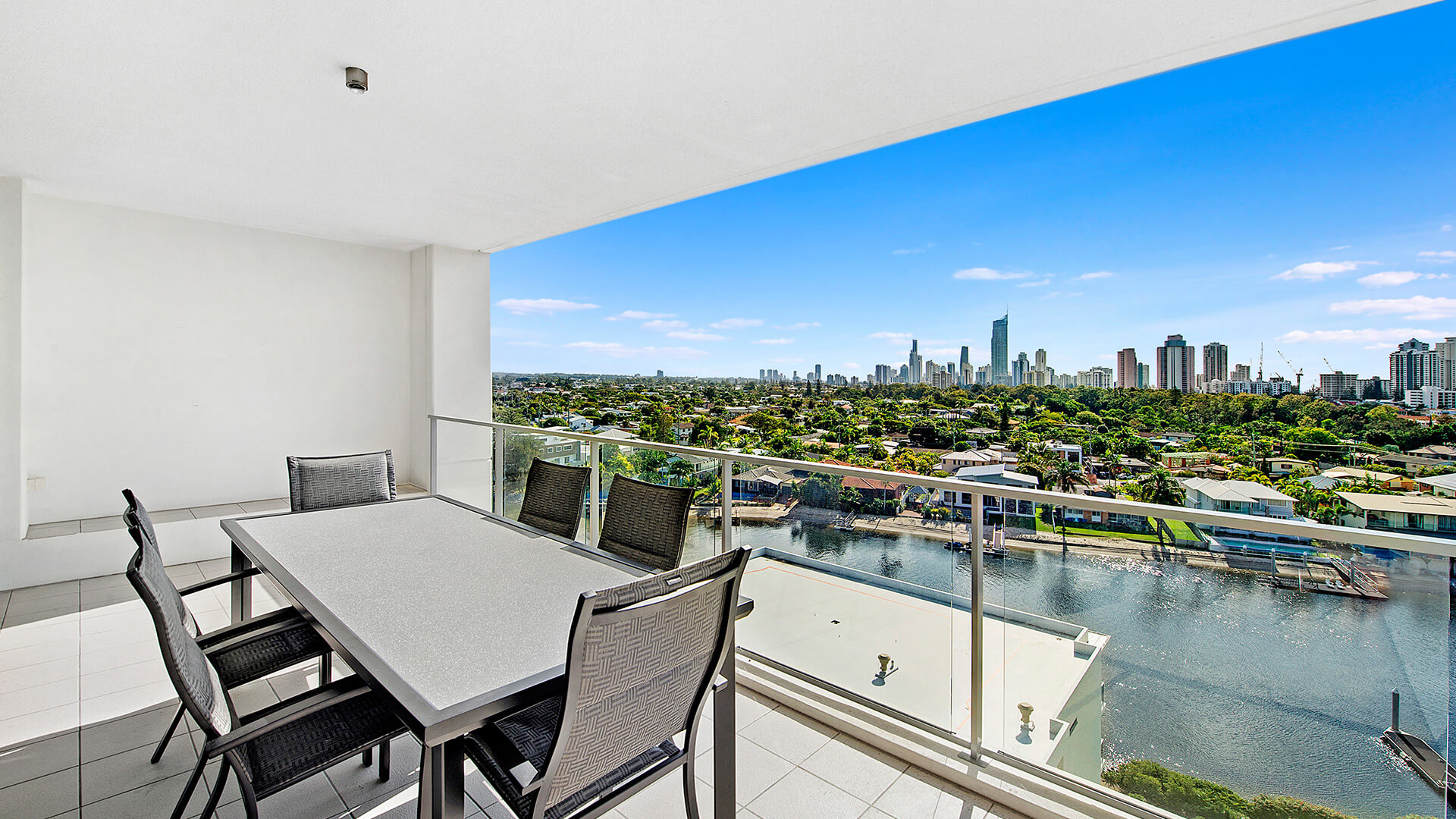 Spacious balcony with outdoor dining and skyline views from the 3 Bedroom Apartment at ULTIQA Freshwater Point Resort.