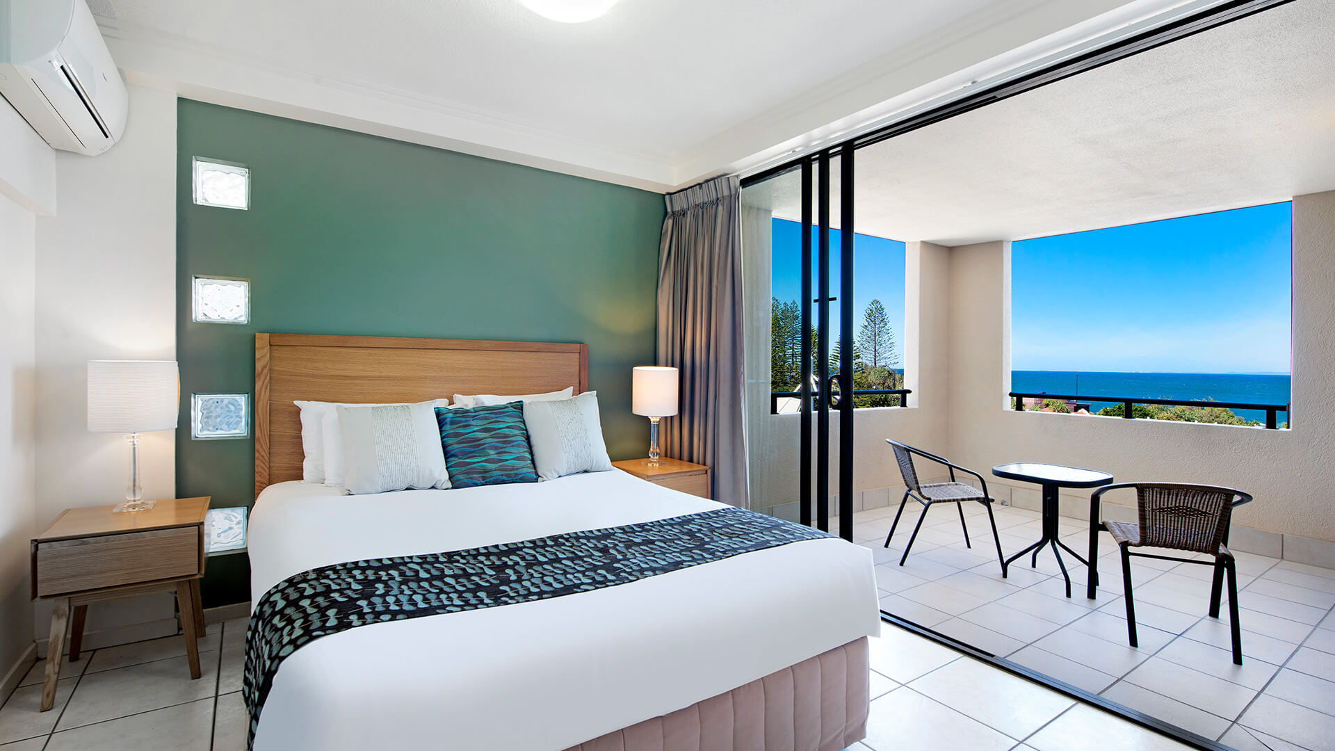 Bedroom with private balcony and ocean views in Studio at ULTIQA Shearwater Resort.