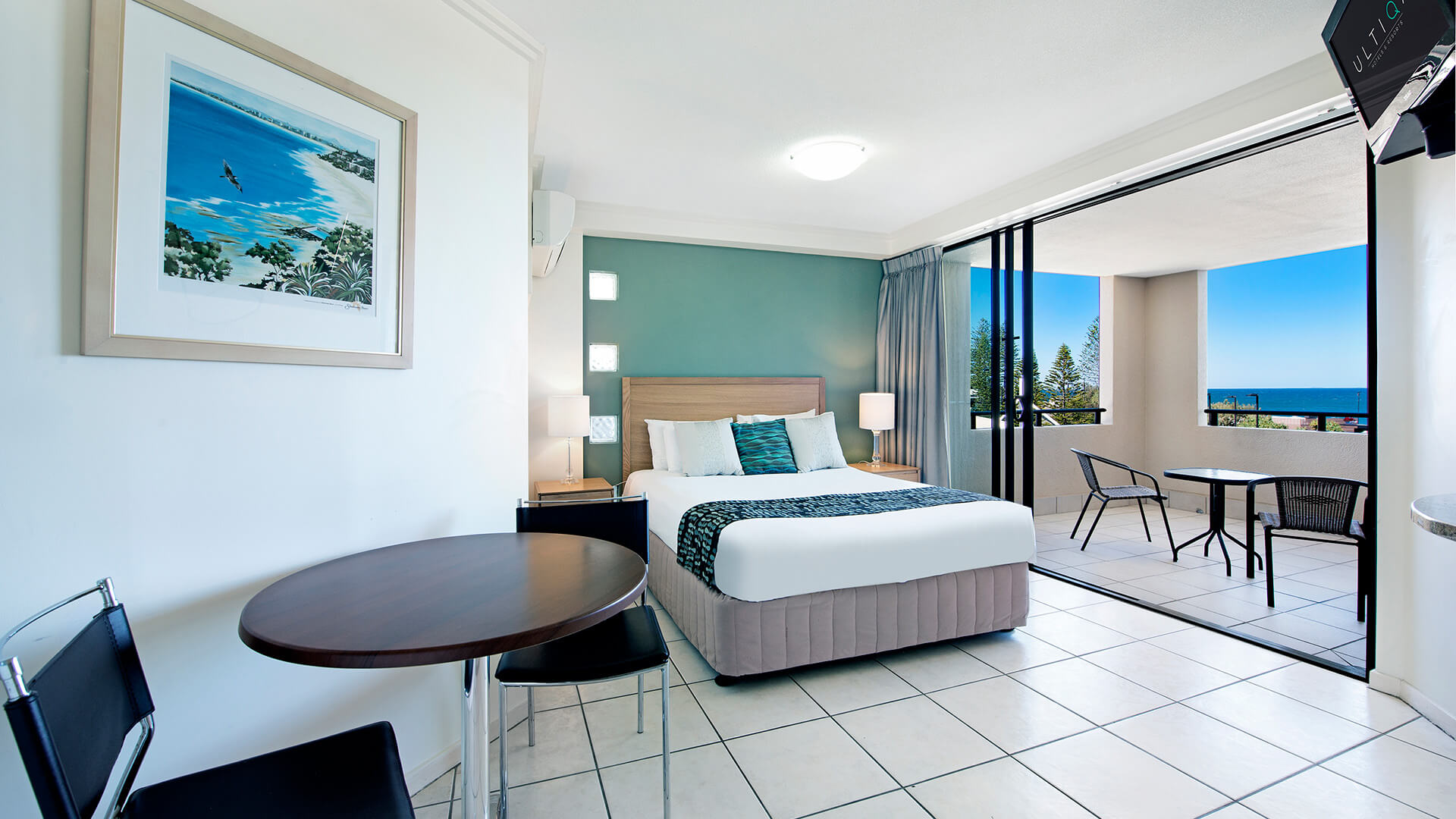 Open-plan Studio with queen bed, dining area, and private balcony offering ocean views at ULTIQA Shearwater Resort.