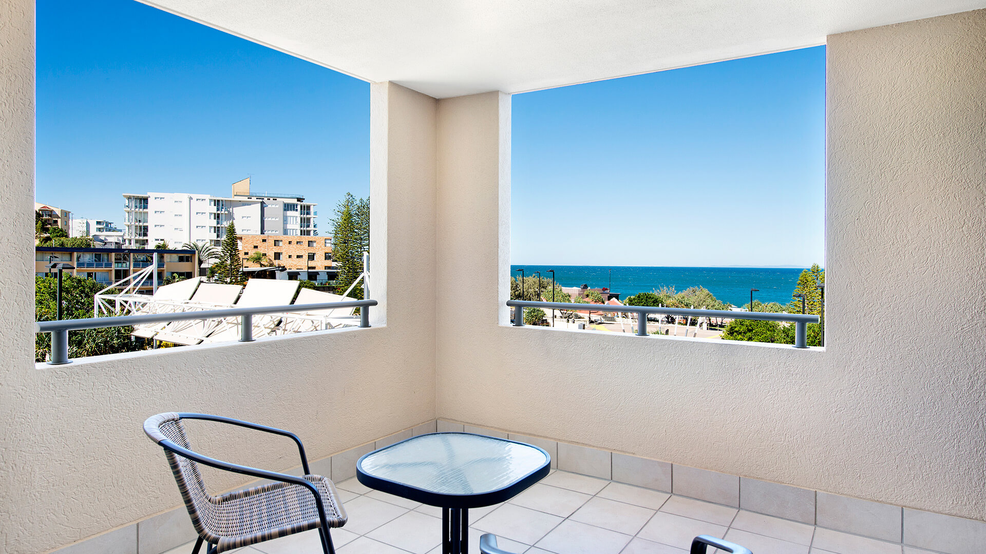 Private balcony with outdoor seating and ocean views in Studio at ULTIQA Shearwater Resort.