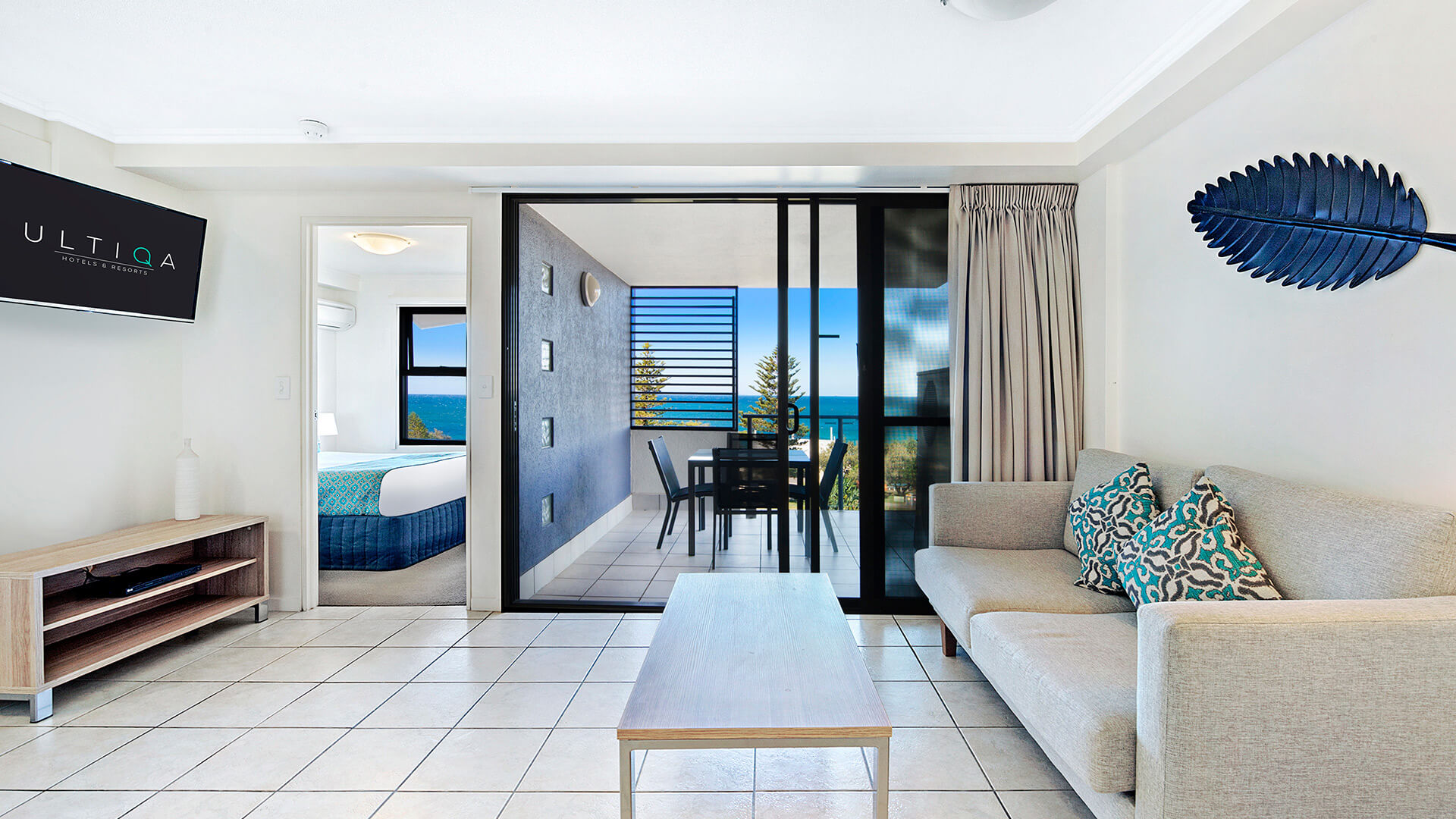 Living area with balcony access and ocean views in 1 Bedroom Apartment at ULTIQA Shearwater Resort.
