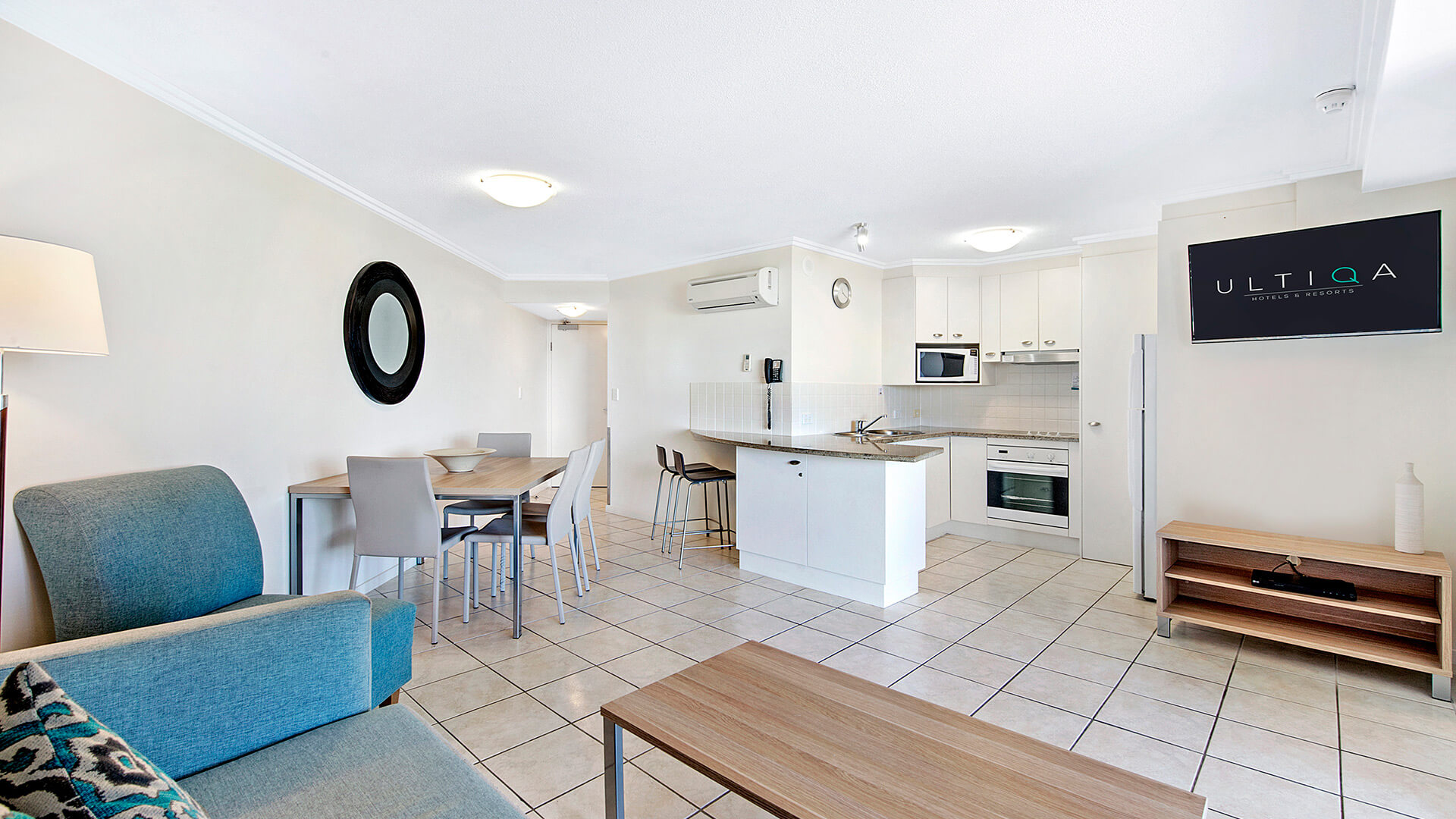 Spacious open-plan living, dining, and kitchen area in 1 Bedroom Apartment at ULTIQA Shearwater Resort.