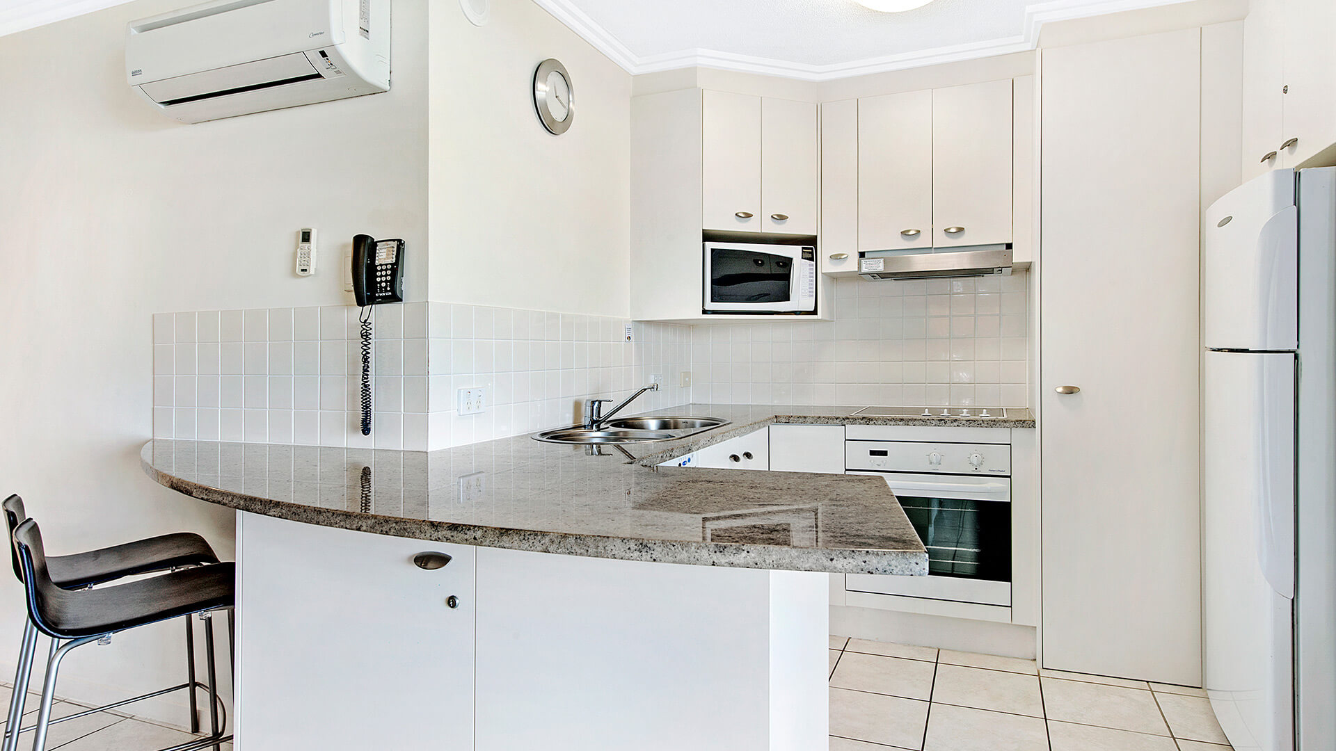 Modern kitchen with breakfast bar in 1 Bedroom Apartment at ULTIQA Shearwater Resort.