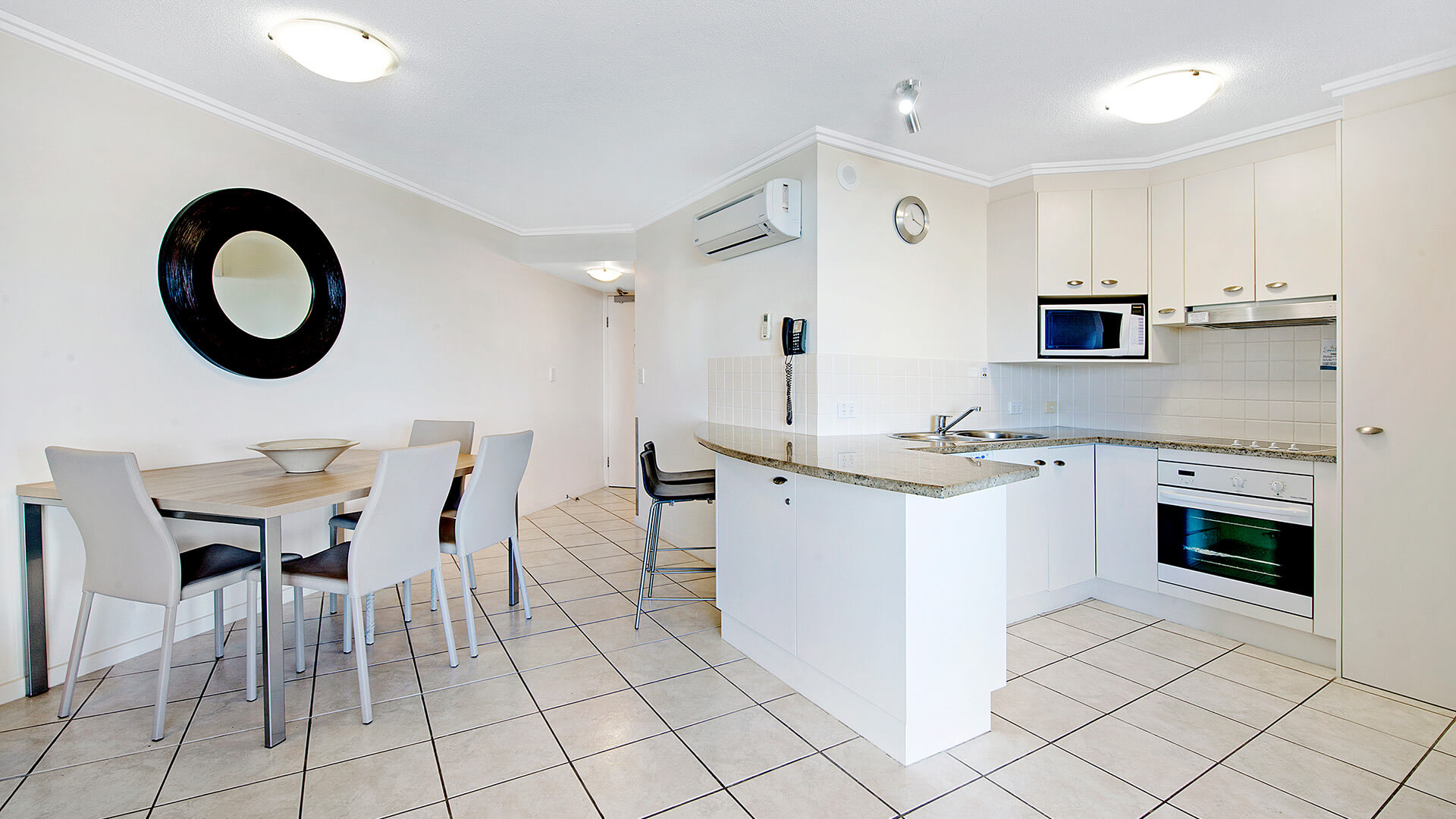 Dining area and kitchen in 1 Bedroom Apartment at ULTIQA Shearwater Resort.