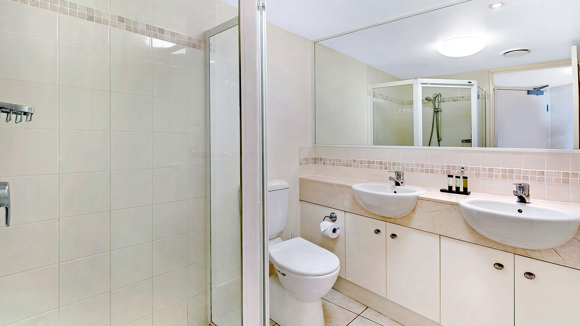 Bathroom with double vanity and walk-in shower in 1 Bedroom Apartment at ULTIQA Shearwater Resort.
