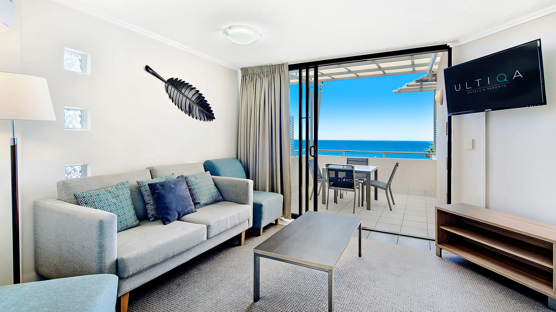 Living area with balcony and ocean views in 2 Bedroom 1 Bathroom Apartment at ULTIQA Shearwater Resort.