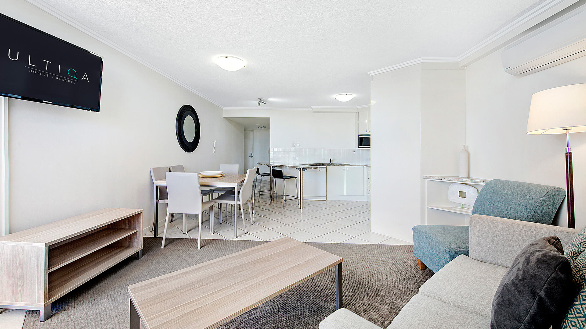 Open-plan living, dining, and kitchen area in 2 Bedroom 1 Bathroom Apartment at ULTIQA Shearwater Resort.