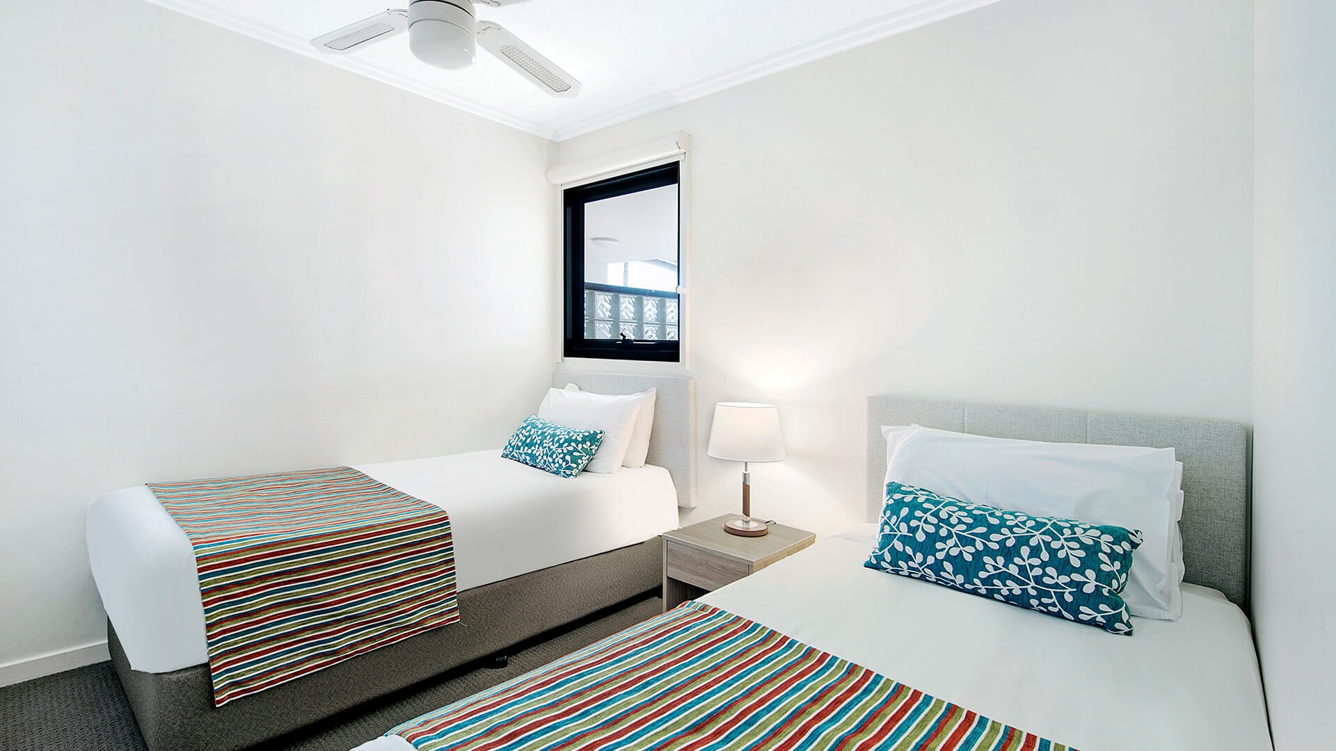 Second bedroom with twin beds in 2 Bedroom 1 Bathroom Apartment at ULTIQA Shearwater Resort.