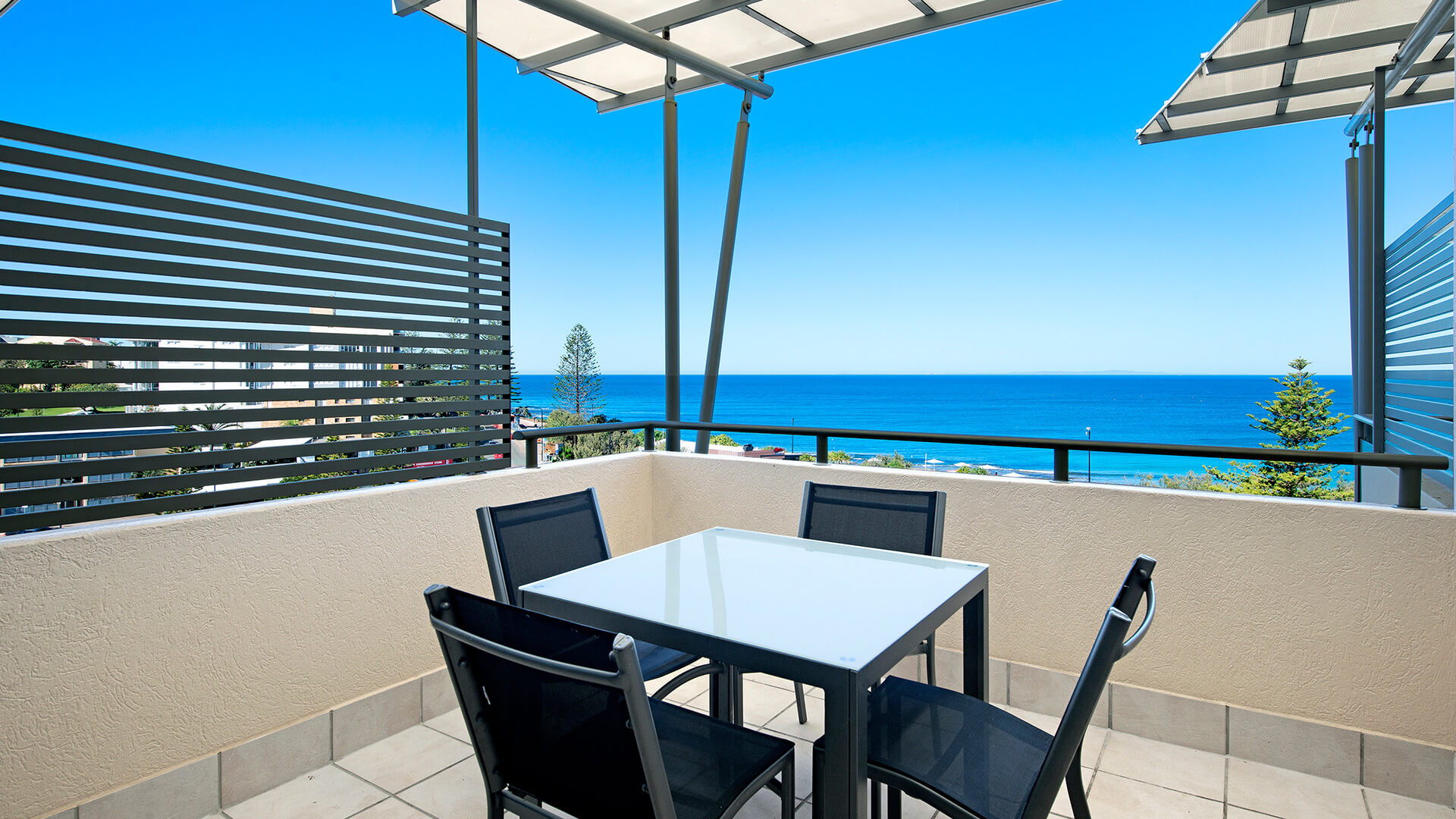 Private balcony with seating and ocean views in 2 Bedroom 1 Bathroom Apartment at ULTIQA Shearwater Resort.
