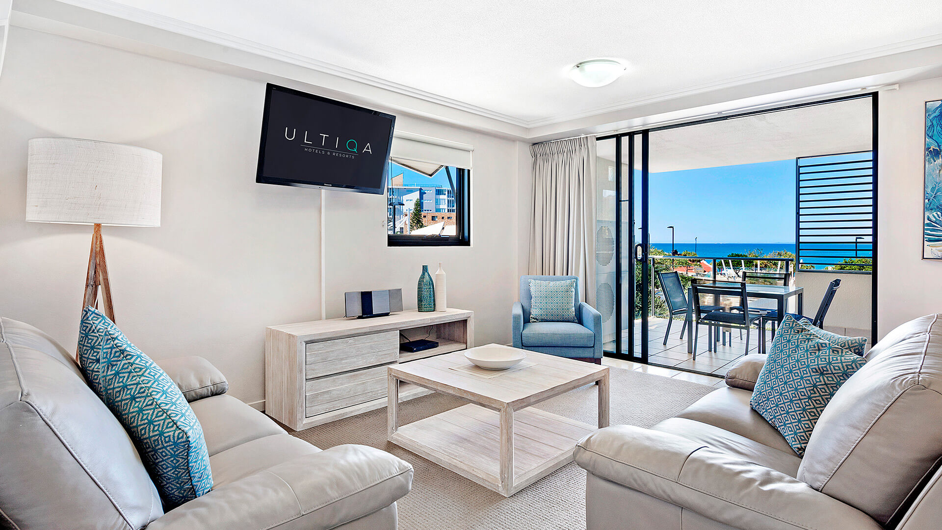 Living area with balcony ocean view in 3 Bedroom Dual Key Apartment at ULTIQA Shearwater Resort.