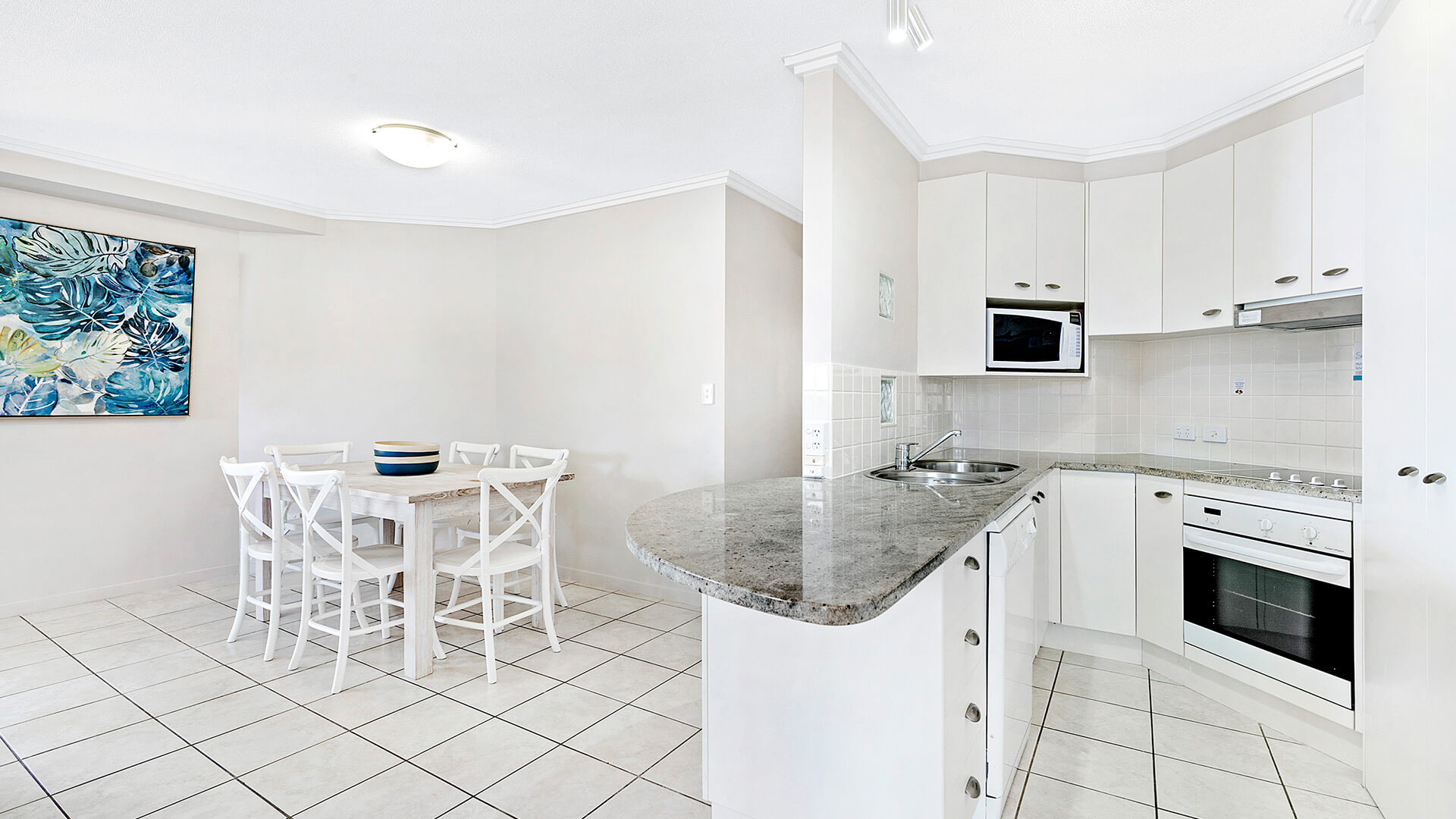 Full kitchen and dining area in 3 Bedroom Dual Key Apartment at ULTIQA Shearwater Resort.