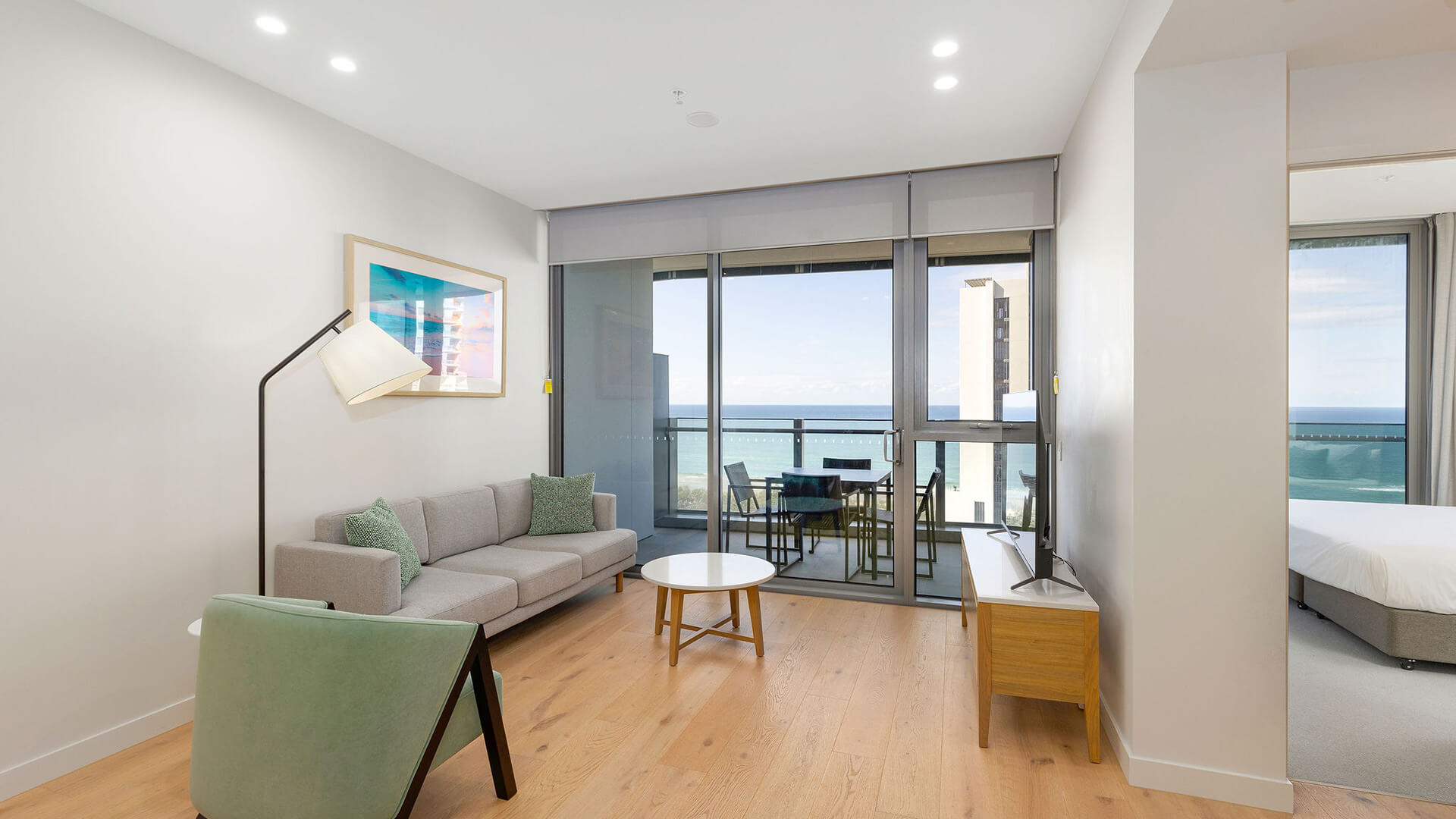Living area and bedroom with ocean views in 1 Bedroom Ocean View Suite at ULTIQA Signature at Broadbeach.