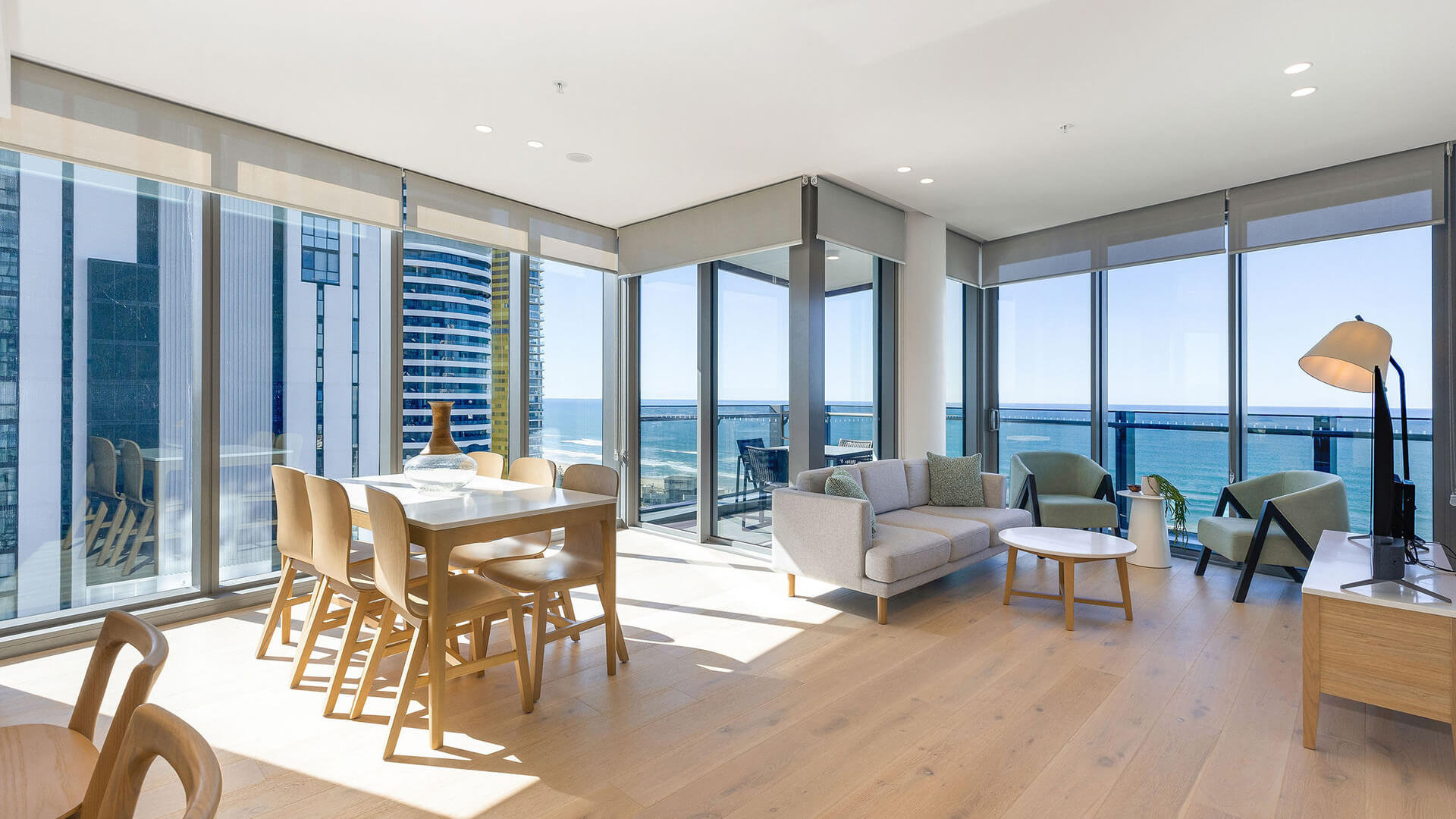 Spacious living and dining area with ocean views in 2 Bedroom Ocean View Suite Premium at ULTIQA Signature at Broadbeach.