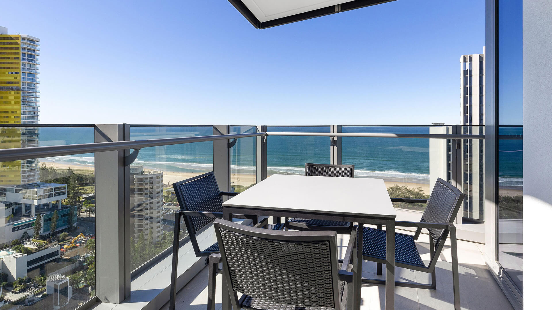 Private balcony with outdoor dining and ocean views in 2 Bedroom Ocean View Suite Premium at ULTIQA Signature at Broadbeach.