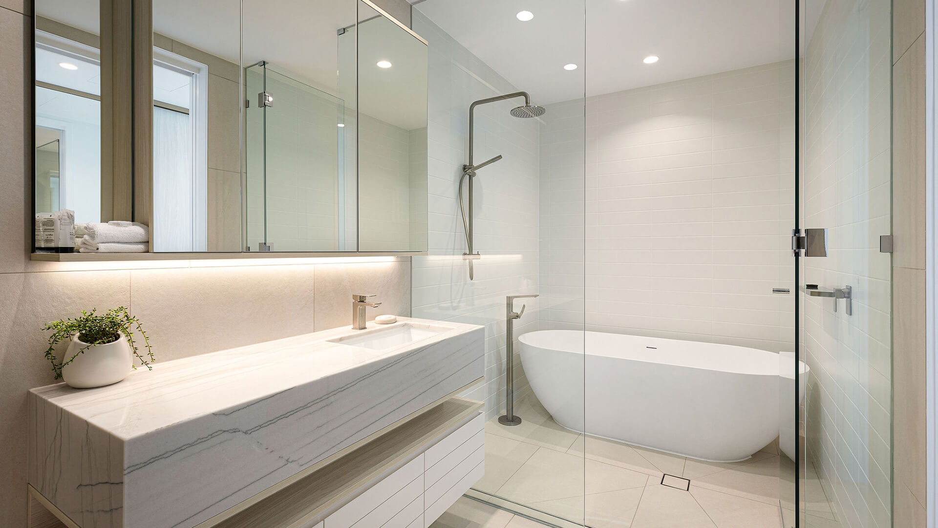 Bathroom in 3 Bedroom Ocean View Suite at ULTIQA Signature at Broadbeach with bathtub and walk-in shower.