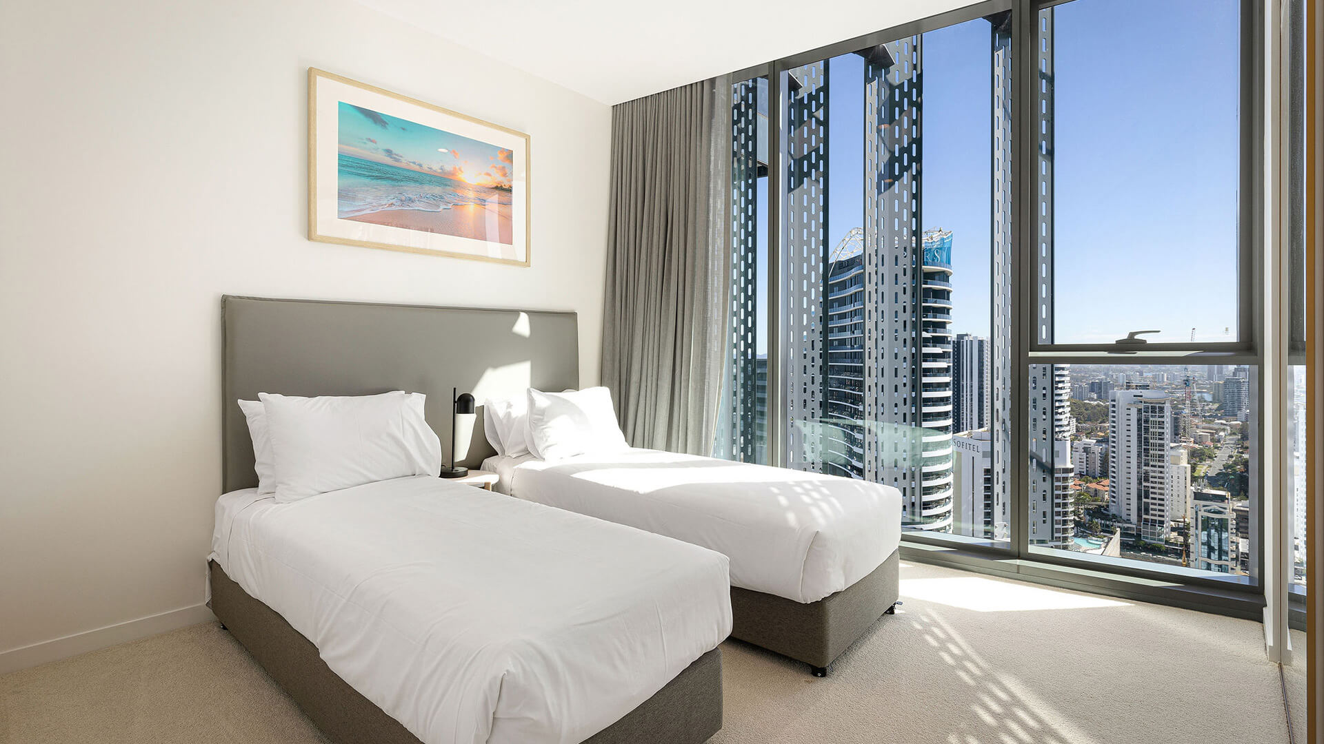 Twin bedroom in 3 Bedroom Ocean View Suite at ULTIQA Signature at Broadbeach with skyline views.