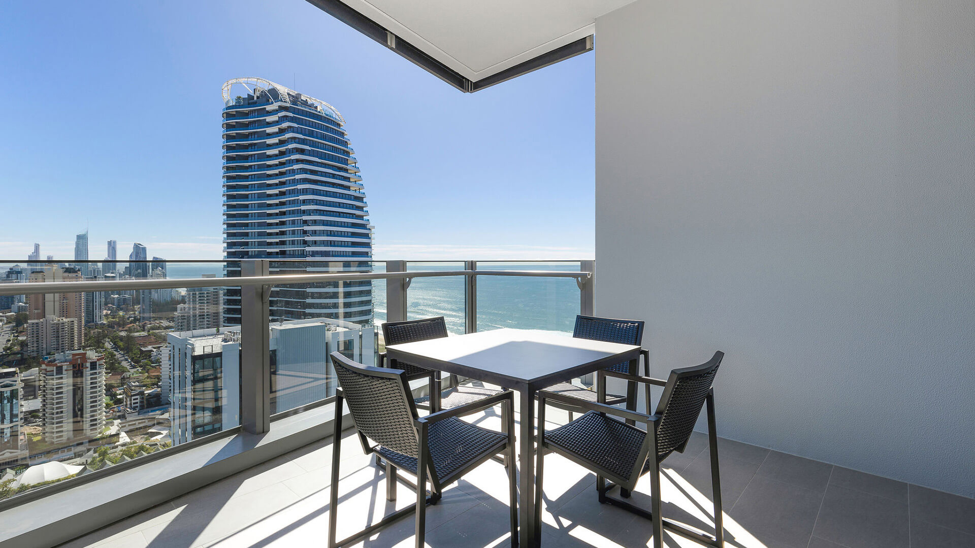 Private balcony in the 3 Bedroom Ocean View Suite at ULTIQA Signature at Broadbeach, featuring outdoor dining and stunning ocean views.