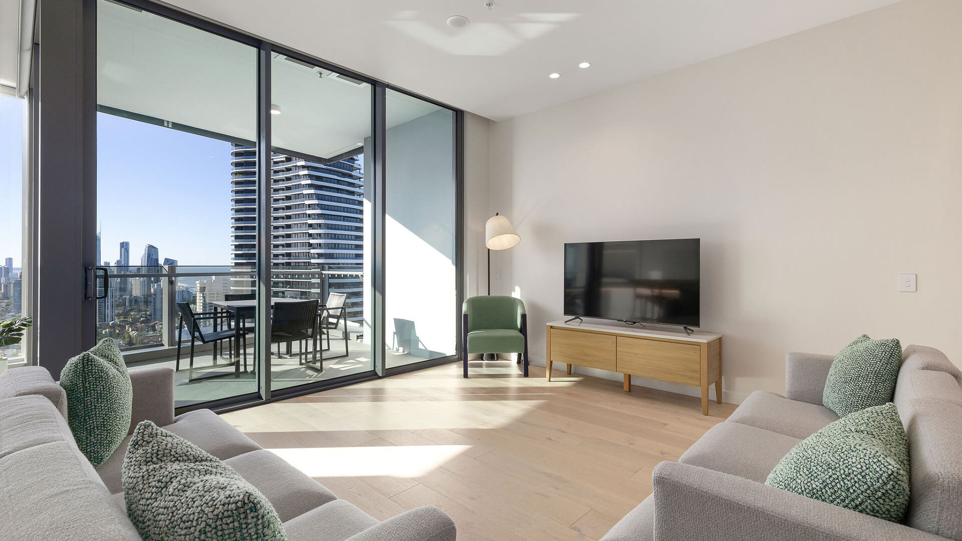 Living area in 3 Bedroom Ocean View Suite at ULTIQA Signature at Broadbeach with balcony access.